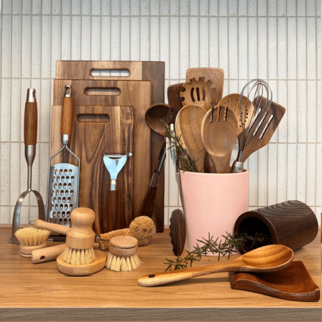 Collection of kitchen utensils and tools on a wooden surface with text 'The Whole Kitchen Reset Bundle'.
